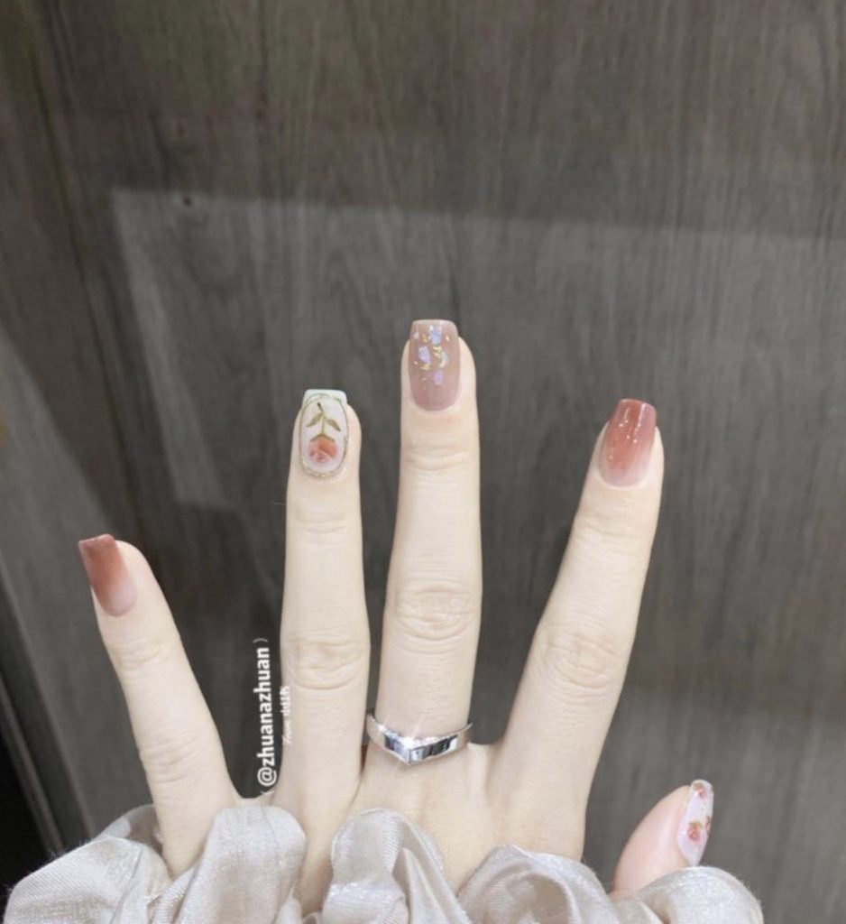 兩隻手指繪上玫瑰花的圖案,無名指以金線框著而拇指則畫上多朵小玫瑰(圖片來源:zhuanazhuan@小紅書)